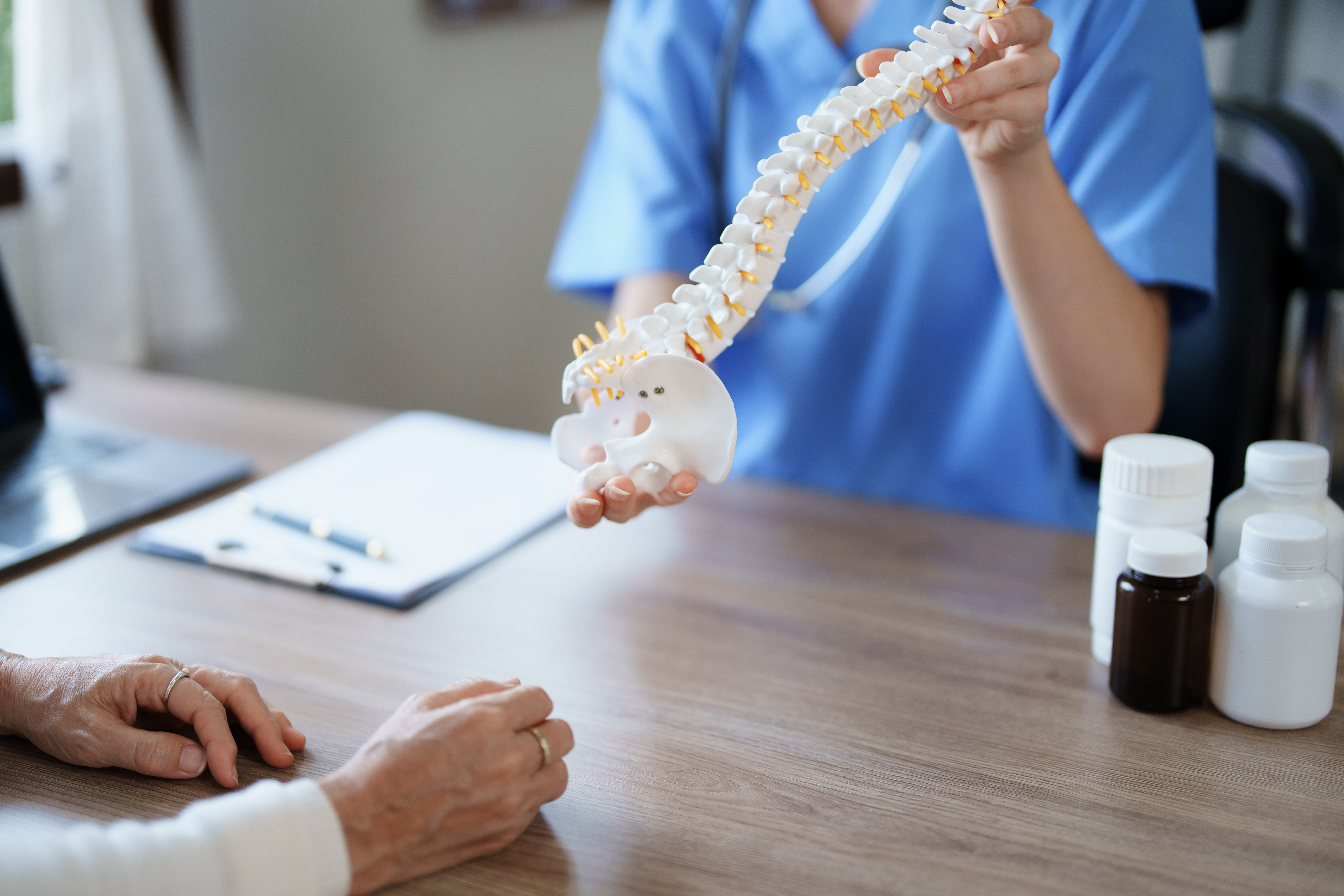 Photo of doctor holding a bone model