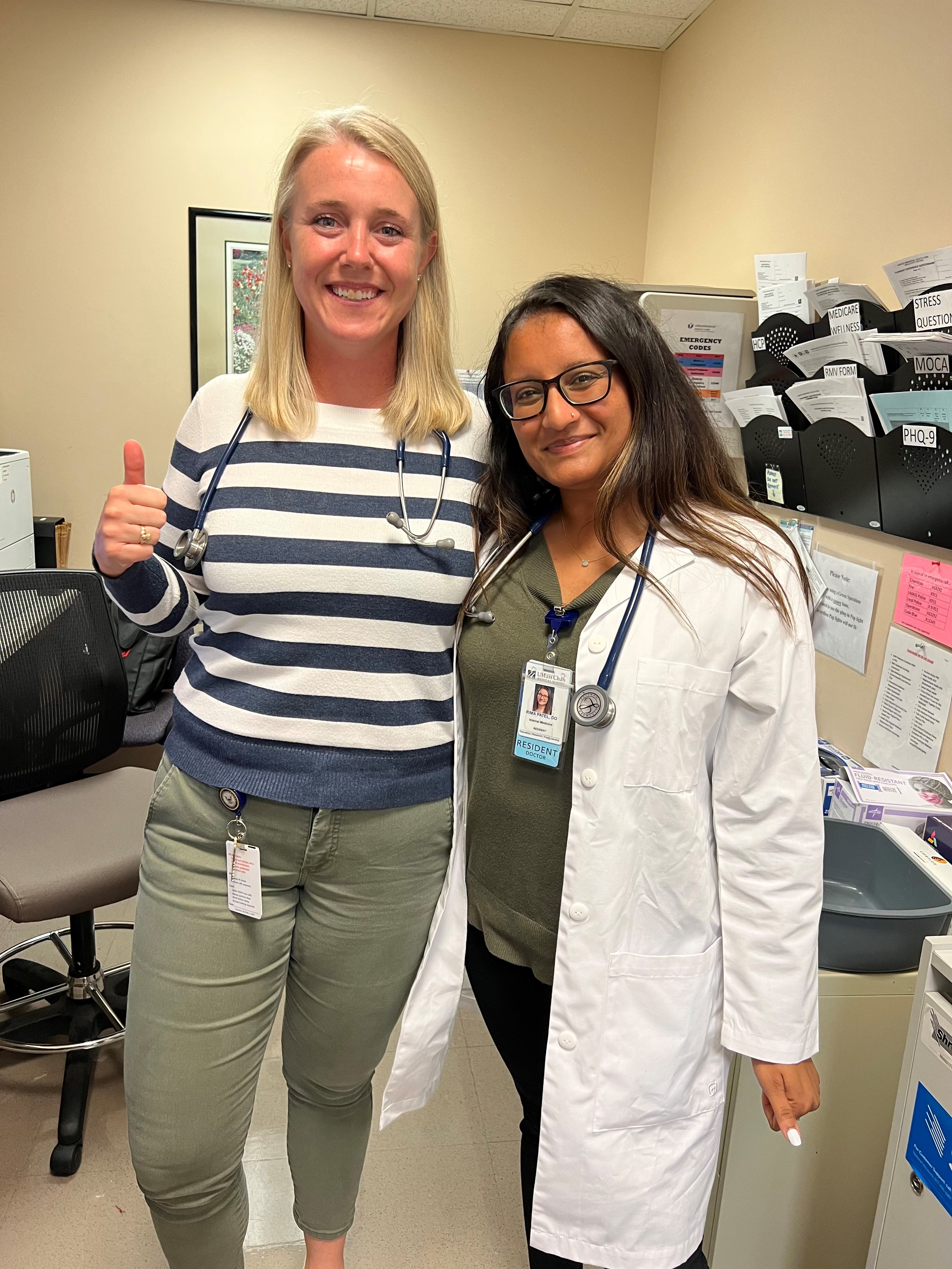 two primary care students posing