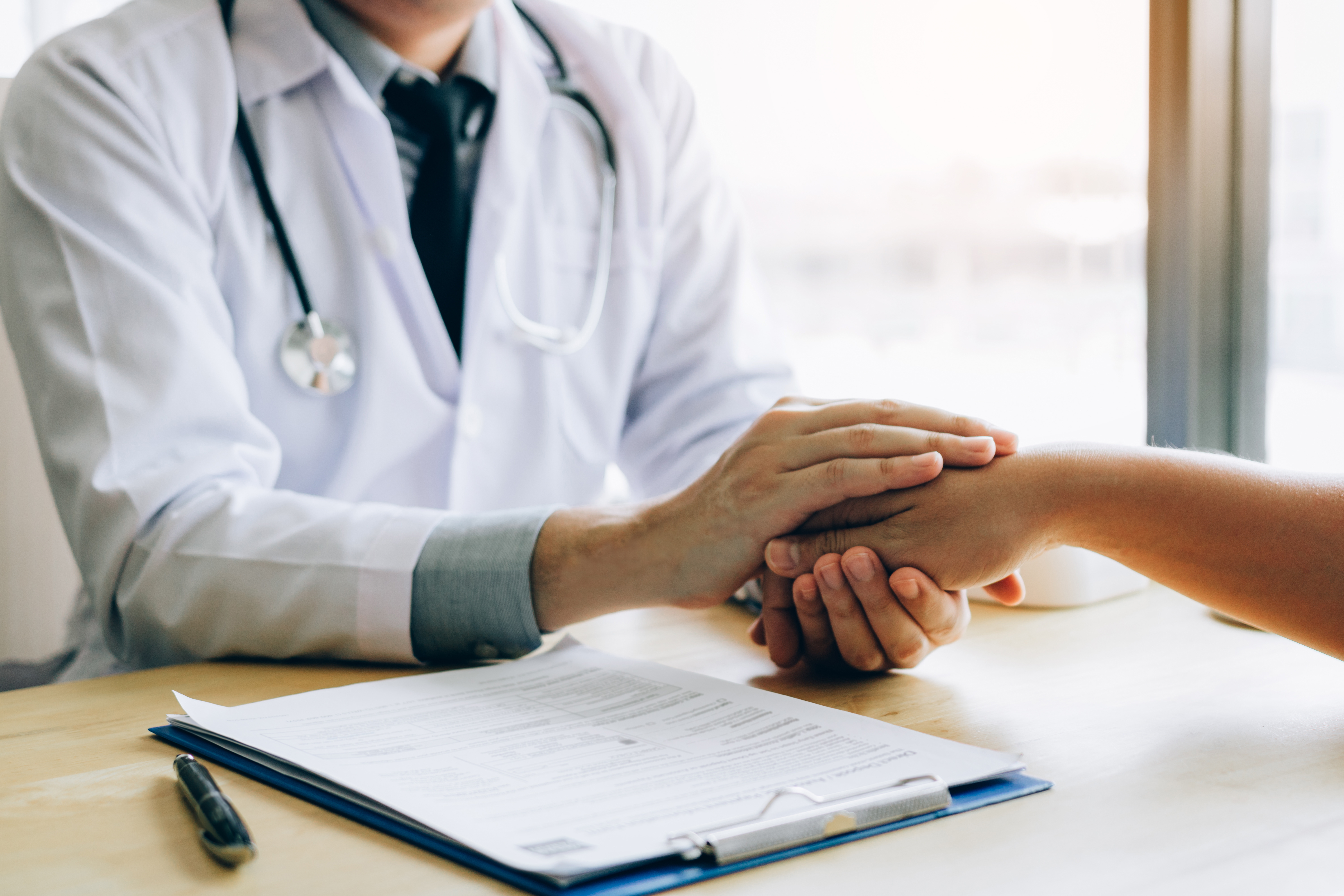 doctor holding a patients hand