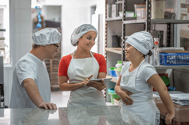 Group of workers conversing in a culinary setting