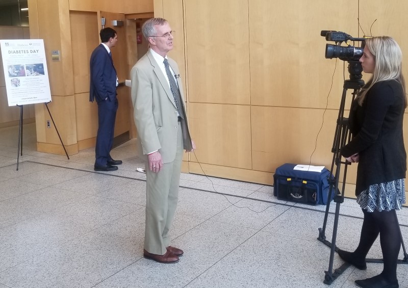 David Harlan, MD, co-director of the Diabetes Center of Excellence speaking with a TV reporter