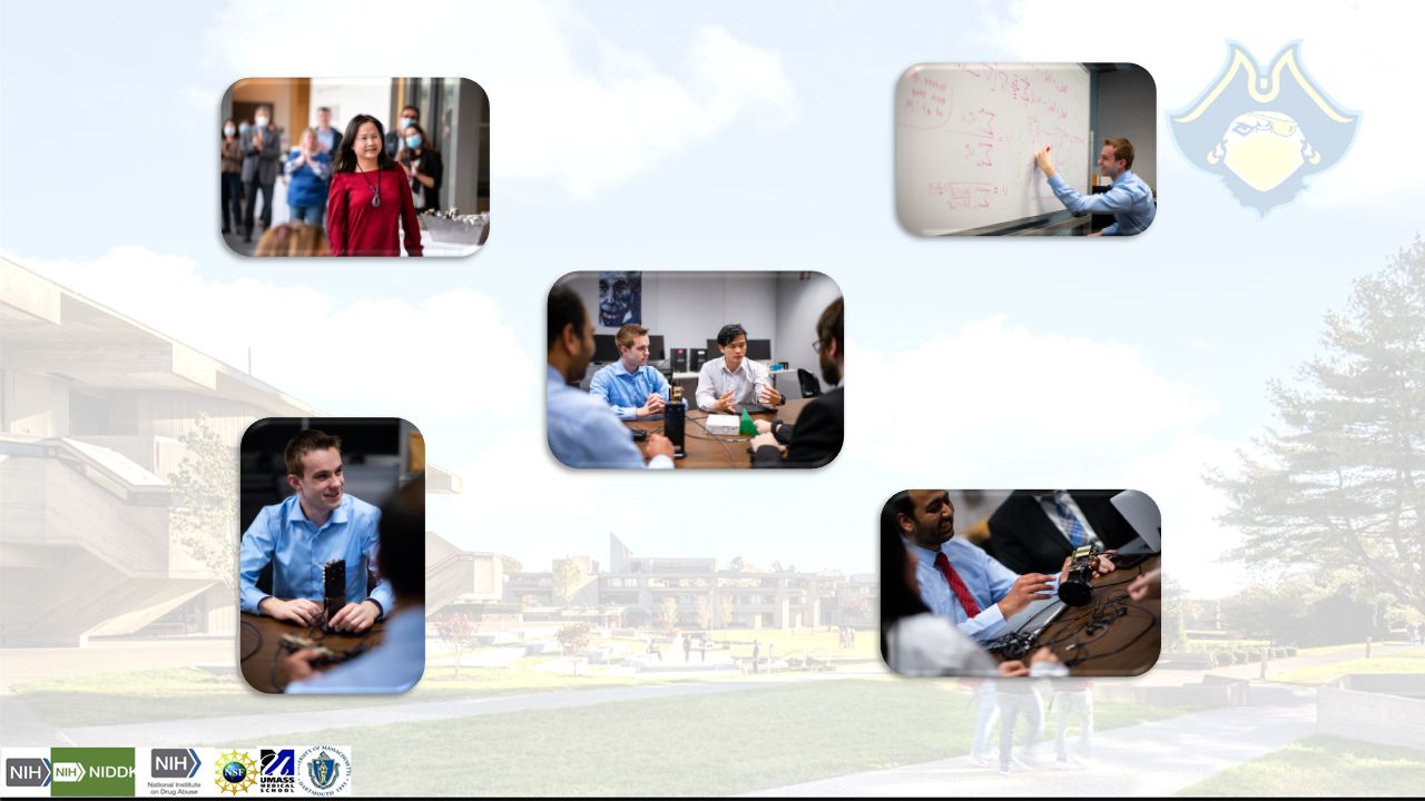 Lab members sitting around a conference table within the office, presenting