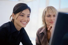 Image of employees at computers in training session