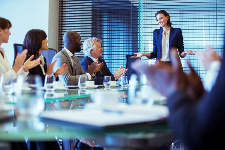 group of people in a conference room presenting