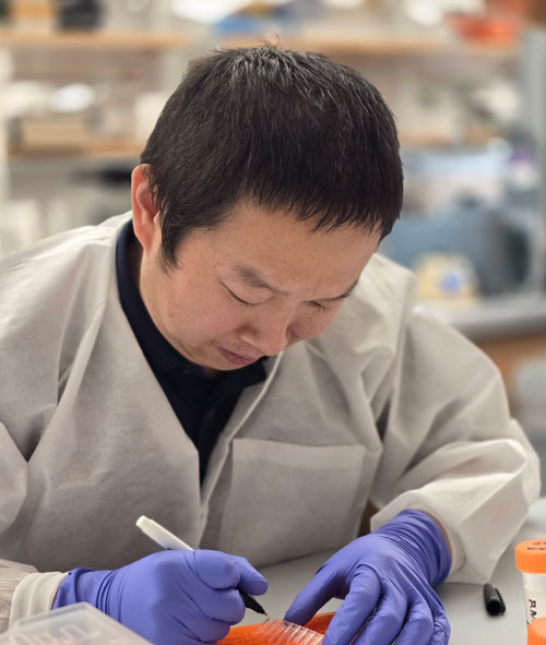 Dongsheng Guo, PhD, in the lab marking samples