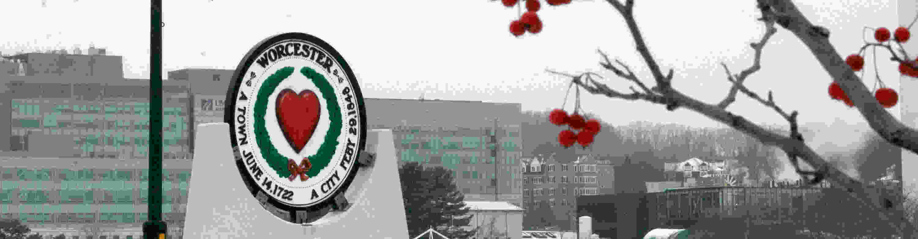 A winter view of campus featuring a circular sign that reads Worcester, A town June 14.1722, A city Feby 29.1848