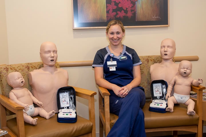 Liz Tollkuci with CPR mannikins