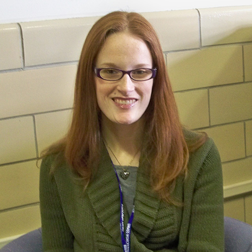 white woman long red hair and glasses