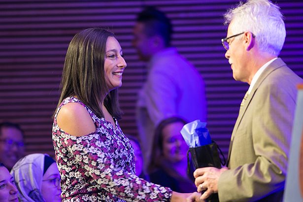 Erica Mondo is congratulated by the dean.