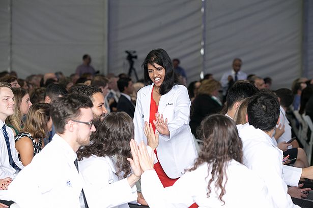 Pooja Gupta is congratulated by her classmates.