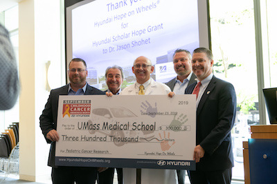 Hyundai Hope on Wheels presents Jason Shohet, MD, PhD, with a grant