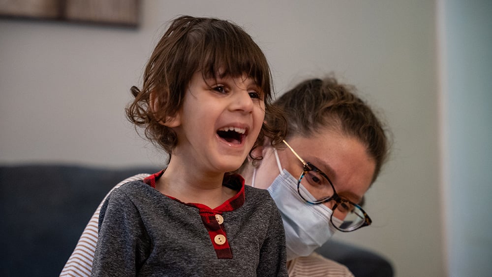 Riaan smiles during physical therapy session with Alexandra Capolla