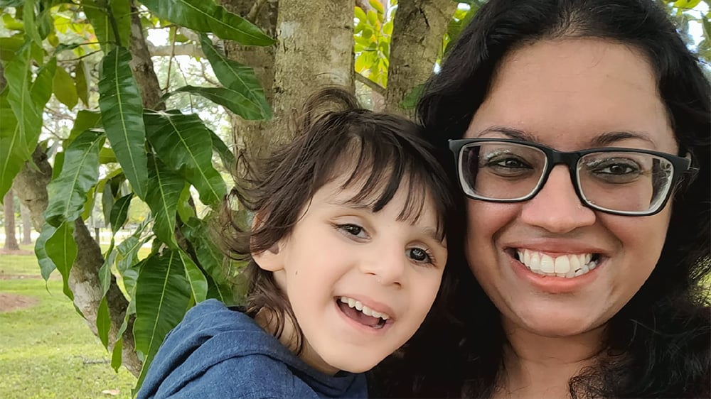 Riaan and his mother, Jo Kaur, smile for a selfie