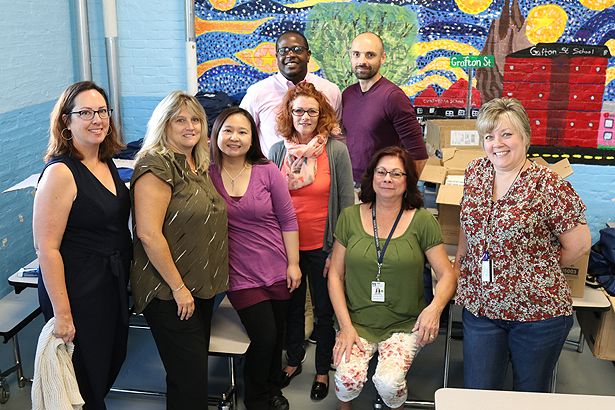 Members of the UMass Chan Medical School community prepare to distribute backpacks to students at Grafton Street Elementary School.