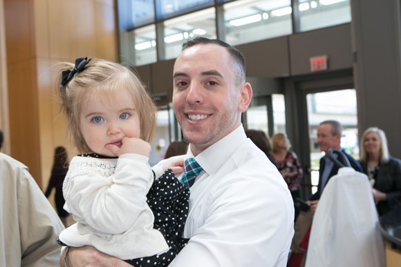 Malek Mazzawi, SOM ’16, holds his niece, Josie, as he waits for the Match Day ceremony to begin.