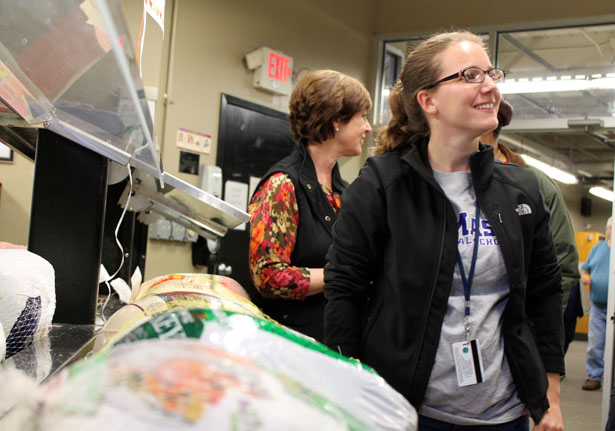 UMass Chan Medical School staff member Stephanie Renk helps Maryellen Collins organize the turkeys for distribution.