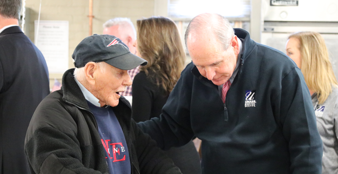 Chancellor Michael F. Collins spends a moment with retired Air Force airman, 3rd Class Thomas Mahoney.