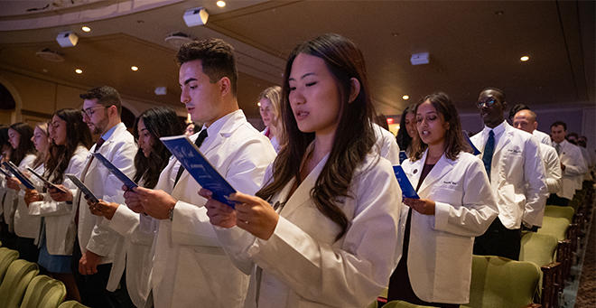  Newly cloaked medical students recite the Oath of Maimonides.