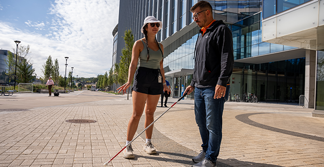 Irina Silverstein standing next to a MassDOT volunteer before being blindfolded.