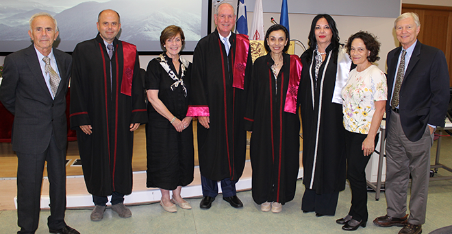 Chancellor Michael F. Collins standing in the middle of a group of eight people