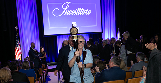 Jean Frazier carrying the Medical School’s ceremonial mace 