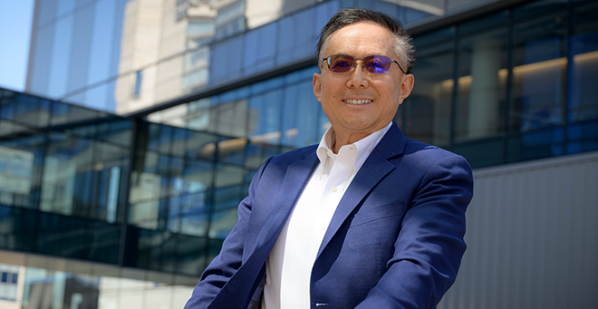 Guangping Gao standing outside of the new education and research building