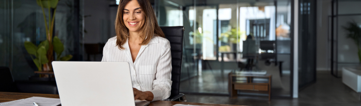 woman typing on laptop in an office setting